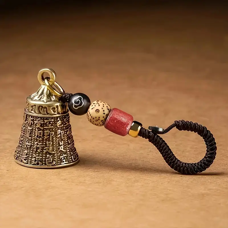 Handmade antique Xizang Bell Keychain with braided rope and beads-complex carving design, red and black beads, gold cover, Buddhist mantra bell, as a gift for good luck, travel, camping and festivals,