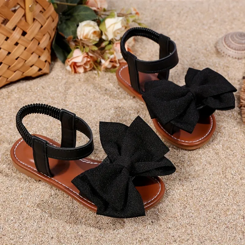 A pair of girls' casual and cute style flat sandals decorated with bows
