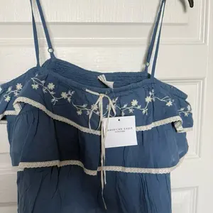 American Eagle Women's Blue Floral Embroidered Ruffle Top with Lace Trim and Adjustable Straps