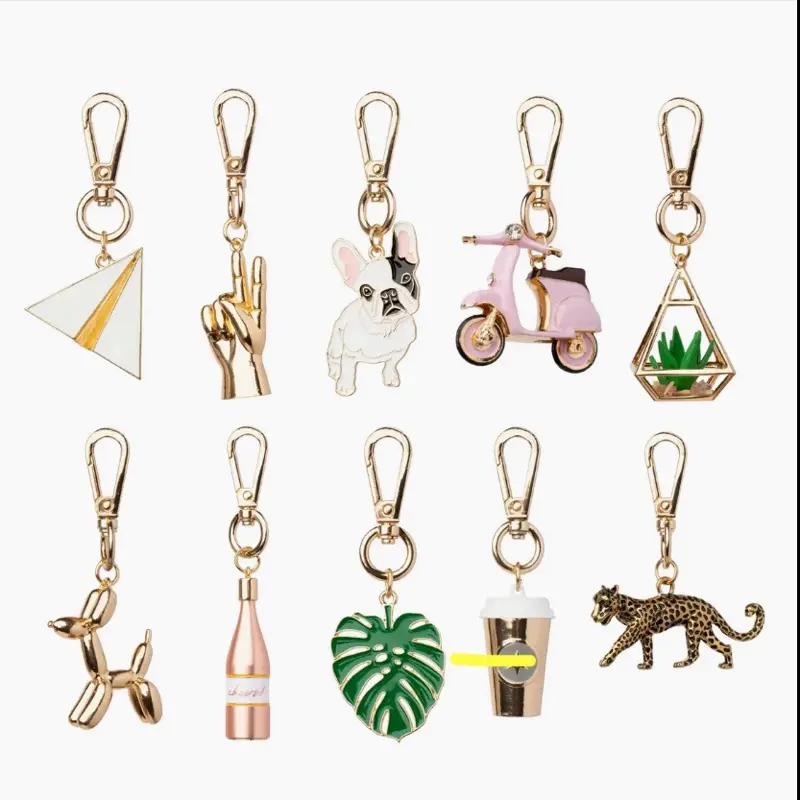 Assorted Keychain Charms Featuring Frenchie Dog, VS Dog, Vespa, Champagne Bottle, Balloon Dog, Monstera Leaf, Coffee Cup & Leopard Design