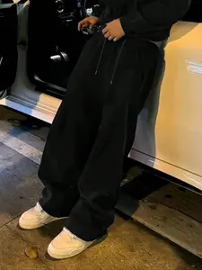 TikTok Trending! Black Baggy Sweatpants, Featuring a Loose Fit and Drawstring Waist, Perfect for Achieving a Stylish, Casual Streetwear Look When Paired with White Sneakers