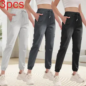 Pack of 3 women’s loose, comfortable jogger pants featuring an adjustable elastic waistband and pockets; simple athletic pants that safely store small items, suitable for everyday wear and relaxing after yoga, showcasing a summery vibe.