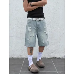 Men’s ripped loose denim shorts, Y2K hip-hop street style, patch appliqué details, wide-leg denim shorts, vintage black wash, knee-length, casual skateboarding shorts, unisex denim apparel. Menswear