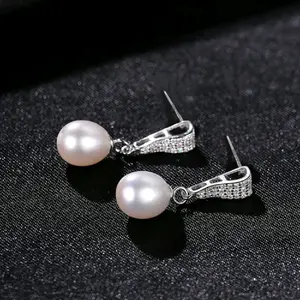 Crafted from pure 925 sterling silver, these exquisite earrings feature natural freshwater pearls, complemented by cubic zirconia accents and a secure push-back closure, designed for women.