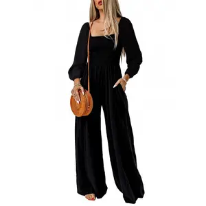 Women’s black square-neck puff-sleeve jumpsuit — structured top paired with high-waisted wide-leg pants featuring pockets; French-inspired elegant vacation outfit with a slimming effect