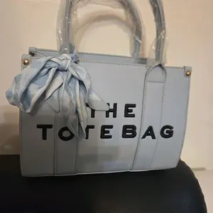 Light Bleu Tote Bag with Stylish Bow Accent and Bold Lettering for Everyday Use