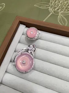 Selina(5776)gc.PINK：Pink donut-shaped chalcedony set pendant and ring, both in white gold. BLUE：Blue star gemstone set ring and pendant, both in white gold.