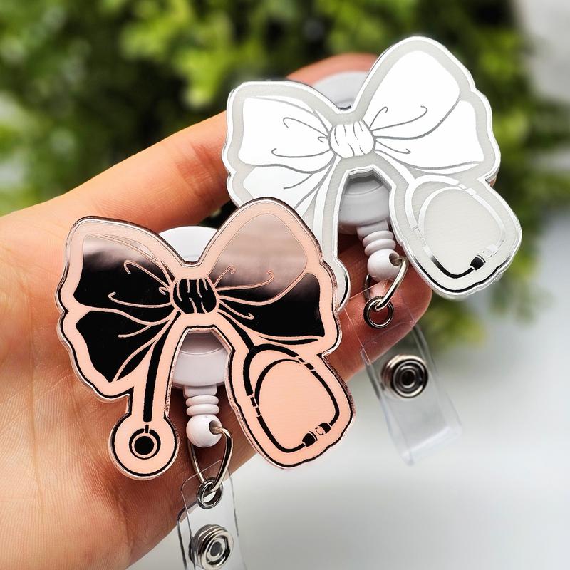 Bow with Stethoscope Badge Reel, Laser Engraved with Smooth Mirror Finish, Funny Badge reel for nurses, xray techs and hospital workers. Retractable swivel clip with a 360 rotation. Great gift for coworker. Cute Badge for Work. Badge clip, Badge pull