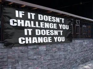 IF IT DOESN'T CHALLENGE YOU IT DOESN'T CHANGE YOU BANNER 48 x 21 Inch Motivational Wall Decor Durable 13oz UV Printed Vinyl with 4 Corner Grommets for Gym Office Garage Workout Poster Style Banner Bold Sturdy Indoor Outdoor Sign