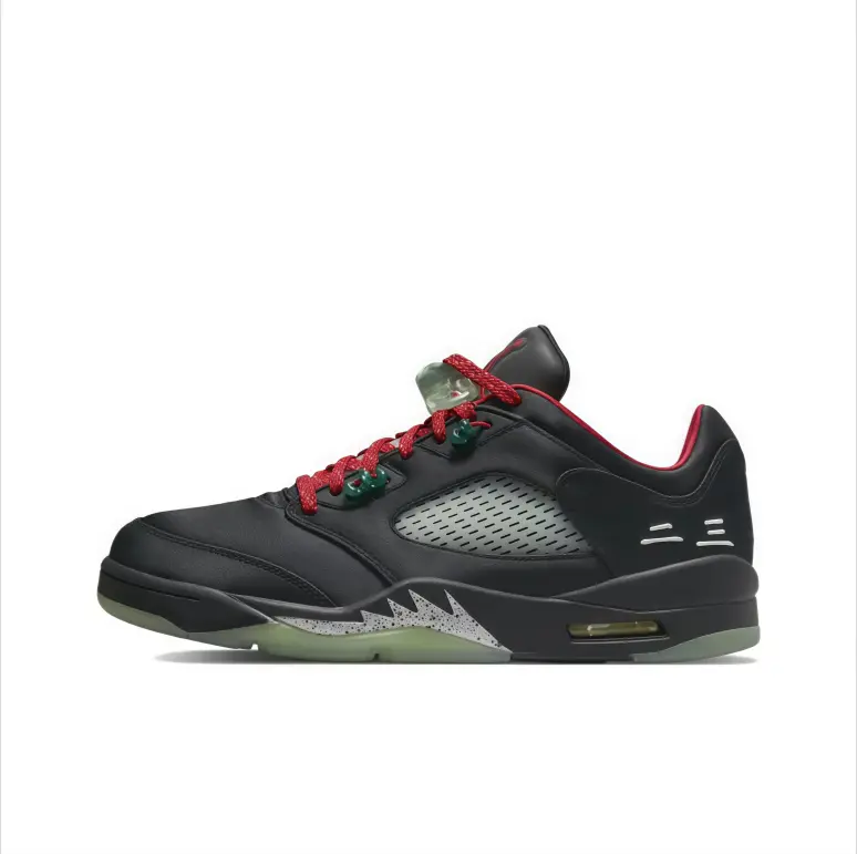 Mid‑top basketball sneakers black smooth leather upper red braided laces green hardware translucent glow outsole speckled jagged trim mesh side panel air cushioned sole street‑wear unisex sport footwear