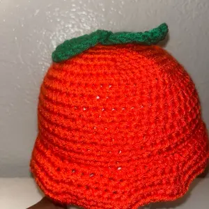 Orange Bucket Hat with Green Leaf Detail for Festive Outfits