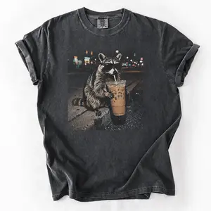 Three Raccoons Drinking Iced Coffee Comfort Colors T-Shirt with a funny Gen Z dank meme vibe, trendy cotton streetwear top and playful graphic gift for men and women alike.