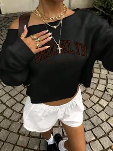 Brooklyn Cold Shoulder Cropped Sweatshirt 🗽✨ 3 colors (white/grey/black) — retro college print, slouchy fit, cutout detail. Perfect for #OOTD, #StreetStyle & casual cool vibes. Soft fabric + Y2K-inspired edge. #NYCFashion #CropTopSweatshirt #ColdShoulder