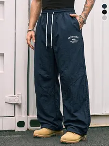 Men’s summer wide-leg casual pants with letter print, elastic drawstring waist, and adjustable hem; breathable fabric suitable for streetwear and everyday wear.