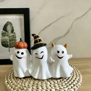 The whimsical trio of Smiling Ghosts - a group of people with crazy smiles - are decorating pumpkins as witches and devils for Halloween.