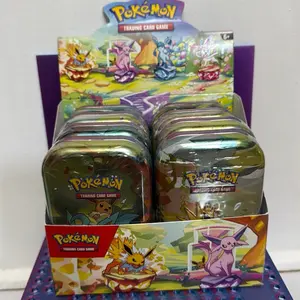 Pokémon TCG: Prismatic Evolutions Mini Tin with 2 Booster Packs, Eevee Coin, and Art Card - Collectible Trading Card Game