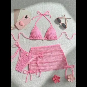 Women’s three-piece plain bikini set featuring a casual tie-back swim top, side-tie bottoms, and a fishing net cover-up swimsuit—fashionable swimwear for beach holidays and vacations; bikini top and trunks.