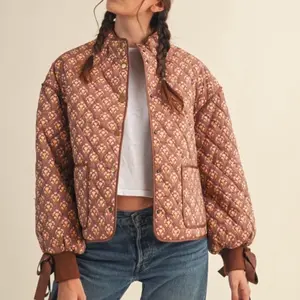 FLORAL QUILTED JACKET WITH TIE RIBBON DETAIL in Rich Brown and Cream Patterns for Stylish Warmth