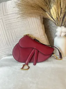 Pre-owned Dior Mini Saddle Bag in vibrant red grained calfskin leather. Features the iconic gold tone D charm 1919H0738