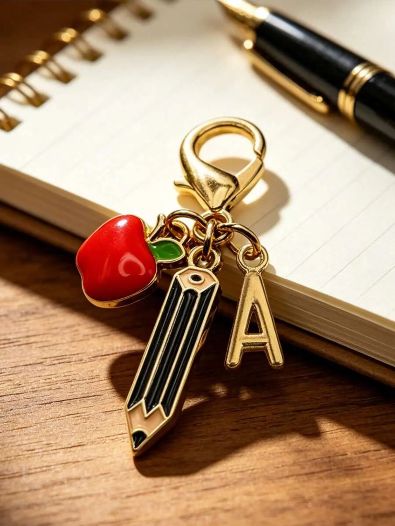 Cute apple-shaped keychain with golden A-Z letters. Premium alloy build, perfect preppy bag charm for teachers. Fits backpacks, wallets, car keys and more. Ideal gift for Teacher’s Day, graduation, back-to-school and birthdays.