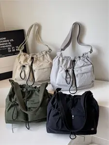 Large-capacity Japanese-style simple drawstring bucket bag for commuting. 2025 autumn new nylon fabric lightweight and versatile shoulder and messenger bag with drawstring cuffs and waterproof nylon material. Suitable for college students, campus, shoppin