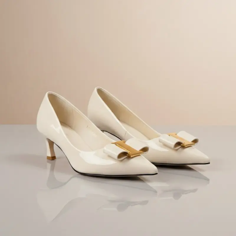 Pointed-Toe Bow Detail Pump in Cream Patent Leather with Gold Accents for Elegant Occasions