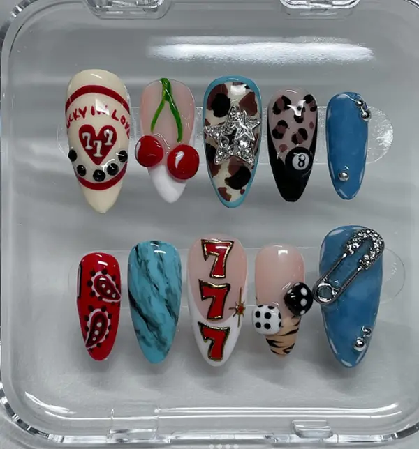 Lucky charms, cherries, dice, leopard print, and bold retro vibes—this nail set is a playful mix of casino glamour and edgy street style.