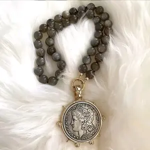 Intuitive Crystal Necklace with Round Beads and Pendant Featuring Ancient Artwork