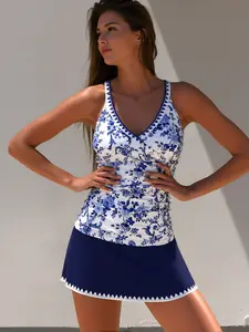 Vintage-inspired modest two-piece tankini set with V-neck, crisscross back, and delicate trim on the flowy swim skirt, made from stretchy, comfortable fabric.swimsuits tummy control.cropped rash guard.beach.curvy size .bathing suits 2026 plus women