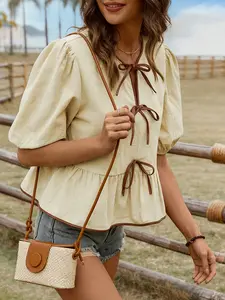 A women's apricot colored fashionable lace up bubble sleeve doll shirt, with a lace up design that adds sweetness. The bubble sleeves cover the flesh and are suitable for commuting to work, shopping, and outdoor wear