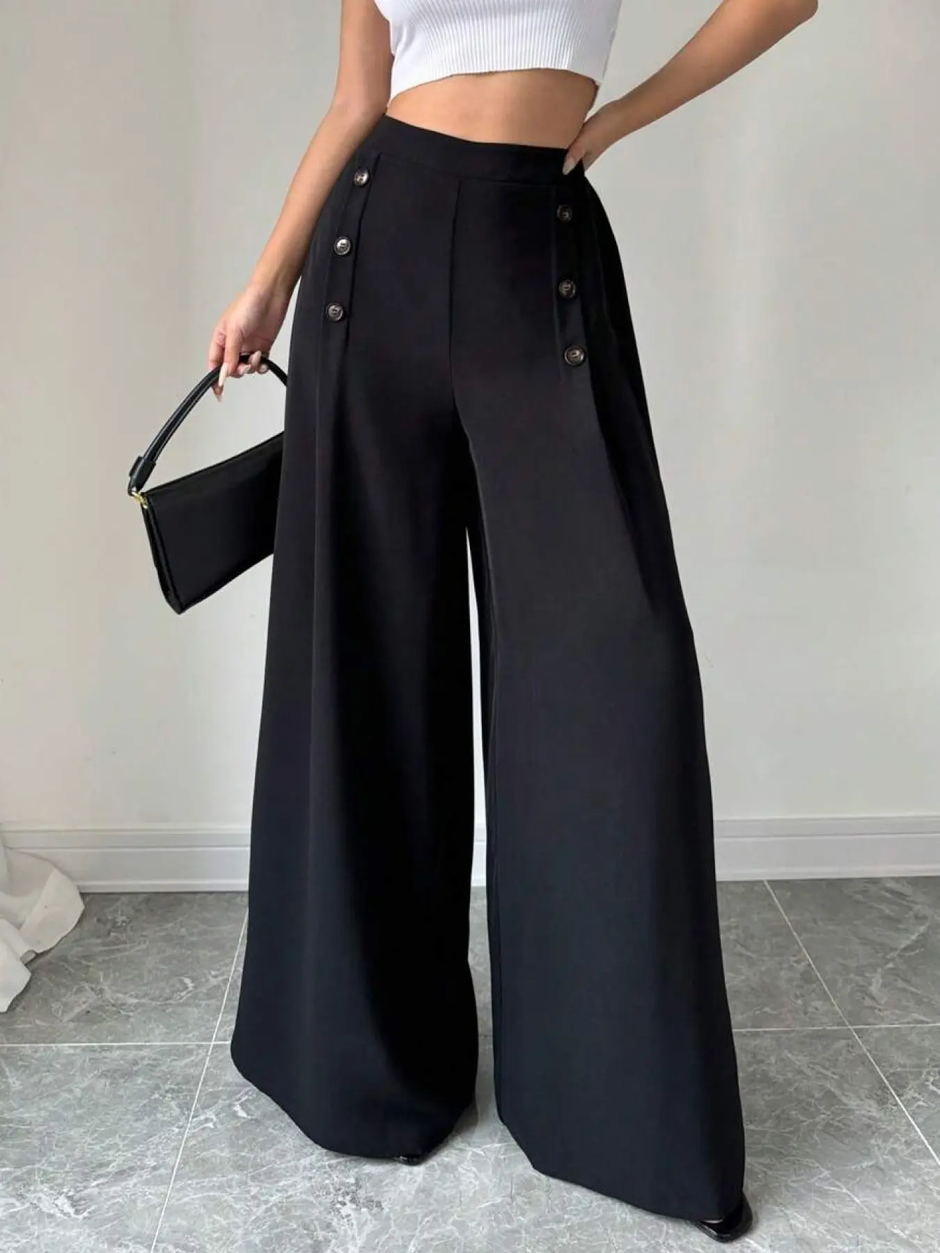 A black high-waisted buttoned dress pants business trousers for ladies, with slimming wide legs. Suitable for both commuting and vacation.