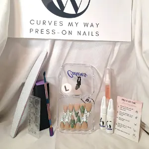 "CMW Press-On Nails: Exclusively in a size large, these stiletto nails feature a nude base with swirling green and white marble accents, adorned with delicate pearl details. Bold, artistic, and ready to impress."