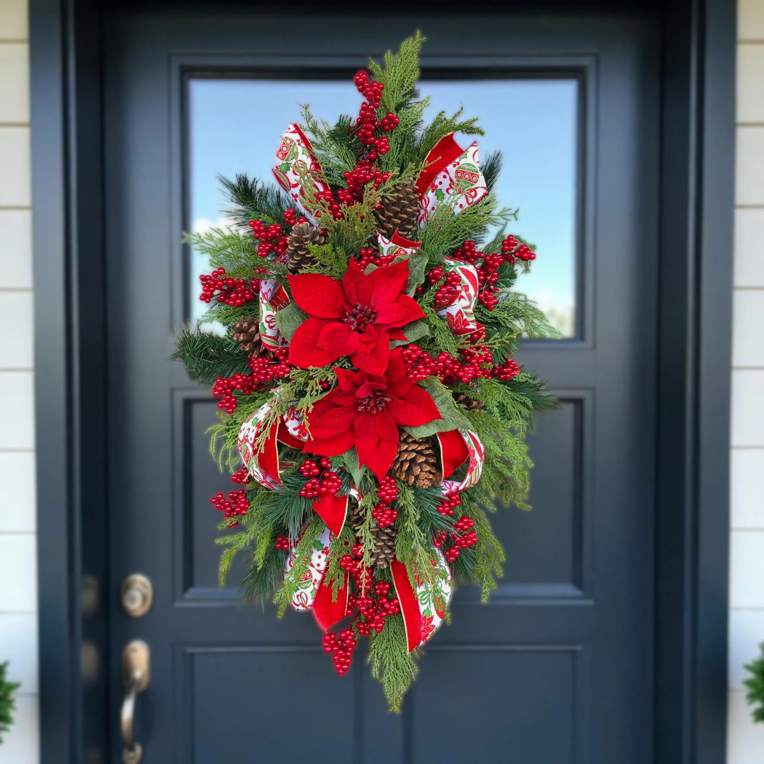 This Christmas arrangement with poinsettias & berries is a winter front door swag or holiday centerpiece for table or mantle Christmas decor