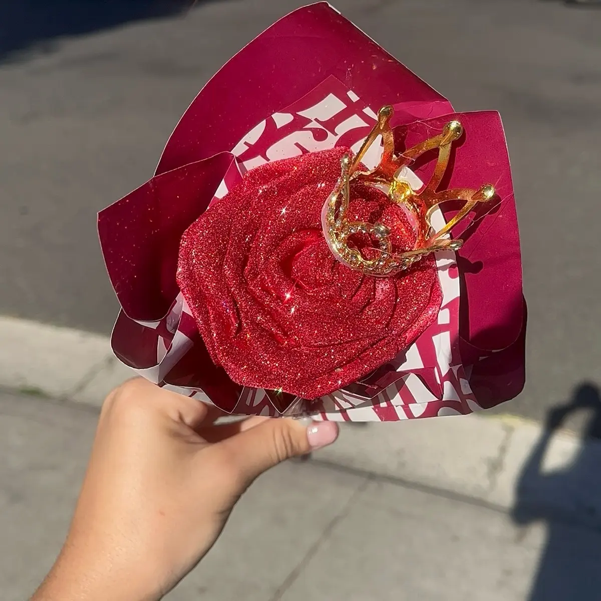 Single red rose with crown