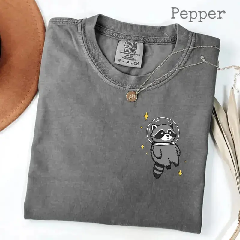 Comfort Colors Space Raccoon T-Shirt with a funny raccoon design, cosmic animal tee style, chaotic vibes, perfect spooky gamer gift idea for everyone