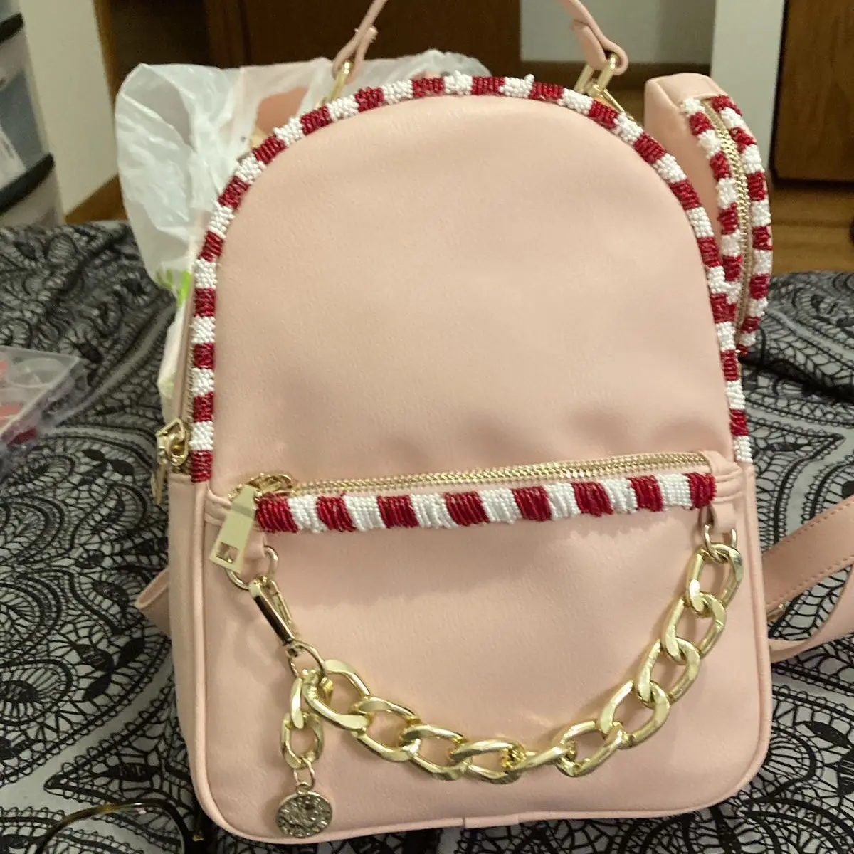 Hand beaded pink backpack with a matching wallet