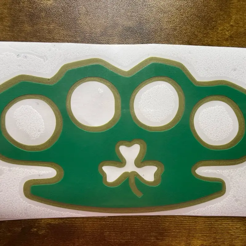 Irish Theme Brass Knuckle Permanent Vinyl Sticker - 5.5in Layered Green and Gold Shamrock Design for Car, Motorcycle Smooth Surfaces, 5.5 Inches