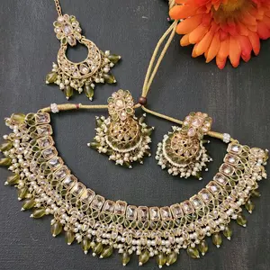 Premium Polki Necklace Earrings and Tika Set with Intricate Design and Rich Green Accents for Festive Wear