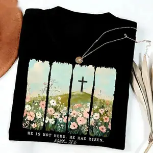 He Is Risen Matthew 28:6 Graphic T-Shirt, Watercolor Wildflower Cross Print Tee, Oversized Comfort Colors Shirt, Christian Easter Casual Short Sleeve Top, Trendy Faith Aesthetic Cotton Tee for Church and Easter Celebrations