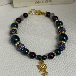 Handmade dragon charm with blue and purple bead bracelet