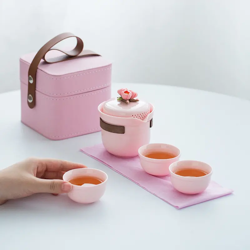 Pink handmade pinch-formed ceramic tea set with 3D floral decoration, portable travel teapot and cups with storage box, suitable for brewing tea