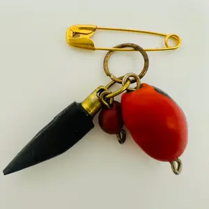 Azabache horn pin with huayruro for protection