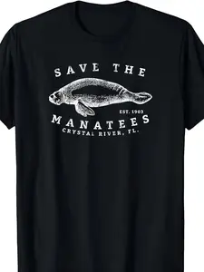 A Black T-Shirt Featuring a White Graphic of a Sea Lion with The Phrase 'Save The Manatees' Established in 1900, Located in Crystal River, Florida. It Has a Straightforward Design Suitable for Casual Wear And Is a Popular Item. The Shirt Offers a Re