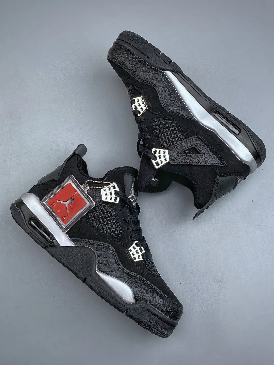 Mid‑top streetwear kicks featuring woven‑mesh mixed construction, bold black base with eye‑catching silver‑white trim details, elevates sharp modern aesthetic for urban casual styling.