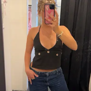 Black Halter Top with Gold Buttons and Deep V-Neckline for Women