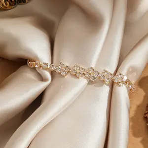 Women's Gold Clover Bracelet with Clear Crystal Accents Dainty Lucky Flower Wrist Jewelry for Daily Wear Elegant and Sparkling