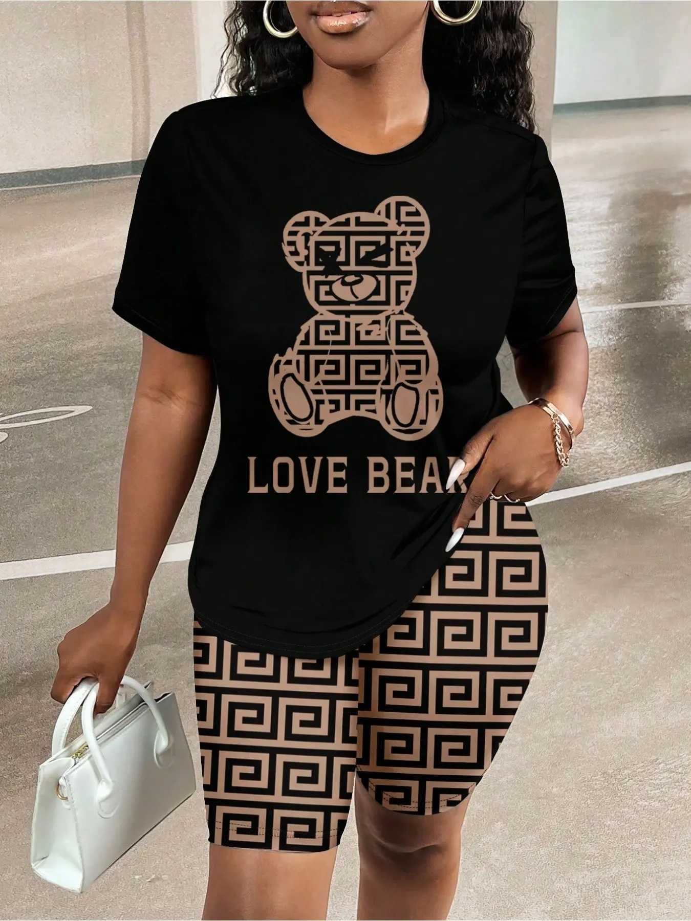 Women’s 2-piece casual Fashion set Womenswear featuring a short-sleeved T-shirt with a lettered bear print and fitted shorts, designed for summer outdoor activities