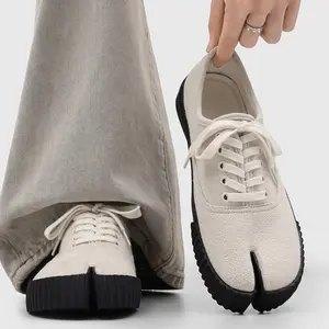 Unisex soft suede toe-post pig-toe low-top lace-up sneakers with a chunky textured saw-tooth sole, minimalist avant-garde style for everyday commuting and walking.