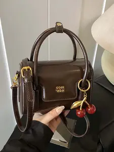 Retro compact mini messenger bag, exquisite cherry pendant, adjustable shoulder strap messenger bag, crossbody shoulder bag, Casual crossbody bags, suitable for daily commuting, shopping, etc.