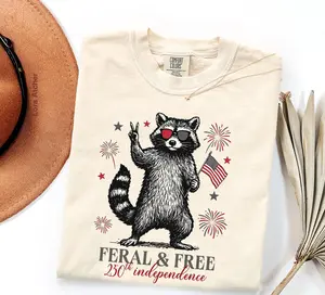 America 250th Anniversary Shirt, Feral but Free Patriotic Raccoon, USA 250th Anniversary Comfort Colors Shirt, USA Flag 4th of July T-Shirt - LORA ATCHER